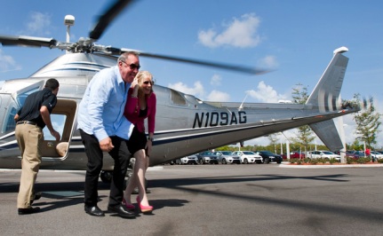 Billy Fuccillo and Caroline Renfro exit a helicopter during a promotional shoot Thursday April 19, 2012, for a $250,000 giveaway at the dealership in May.